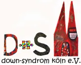Logo of the association “Down Syndrome Cologne e.V.”: The letters “D S” are artistically designed, with a colorful puzzle piece in between. On the right, Cologne Cathedral is painted in red with the inscription “Köln.” Below, the text “down-syndrom köln e. V.” appears in black.